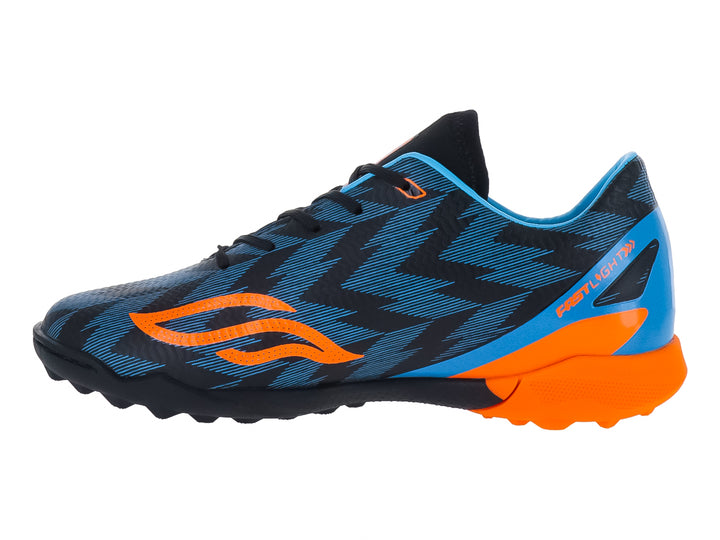 Zapato de fútbol infantil Furia color azul con detalles naranjas y suela negra para césped sintético.