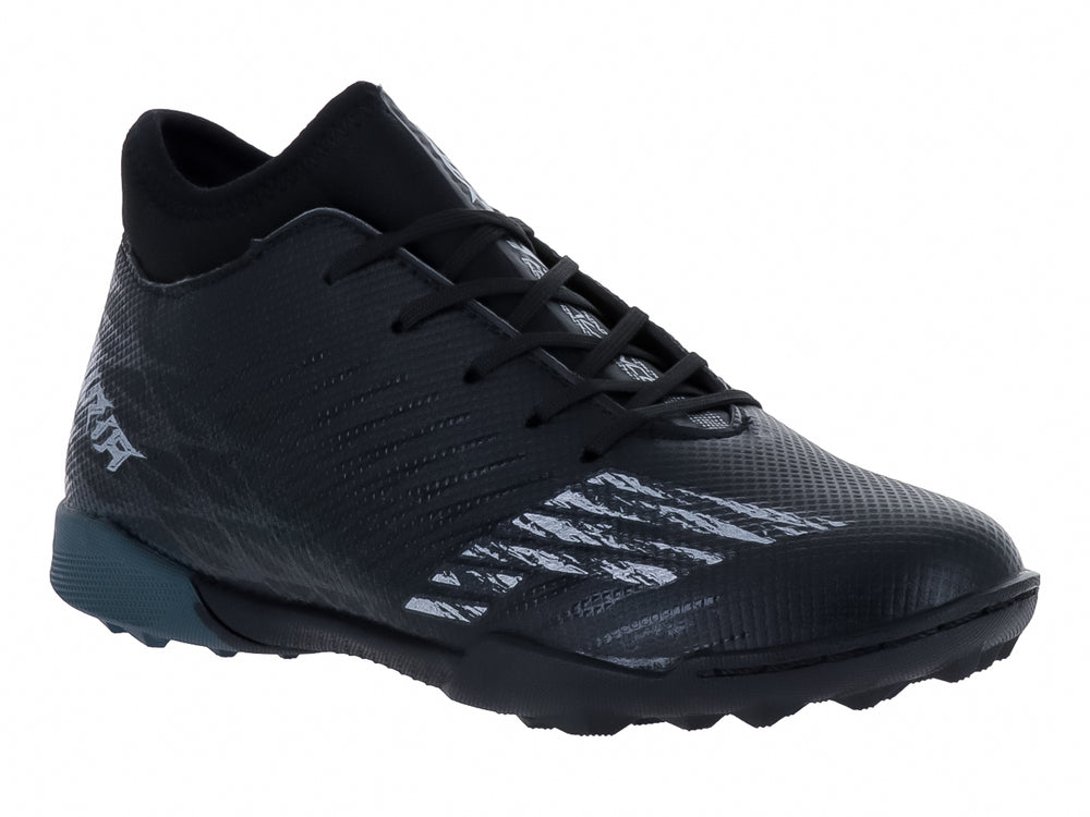 Zapato de fútbol Furia para niño en color negro con detalles en gris oxford y suela para césped sintético.
