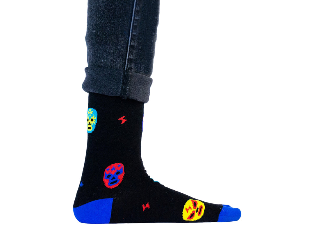 Par de calcetines negros con estampado de máscaras de lucha libre en amarillo y rojo y detalles en azul.