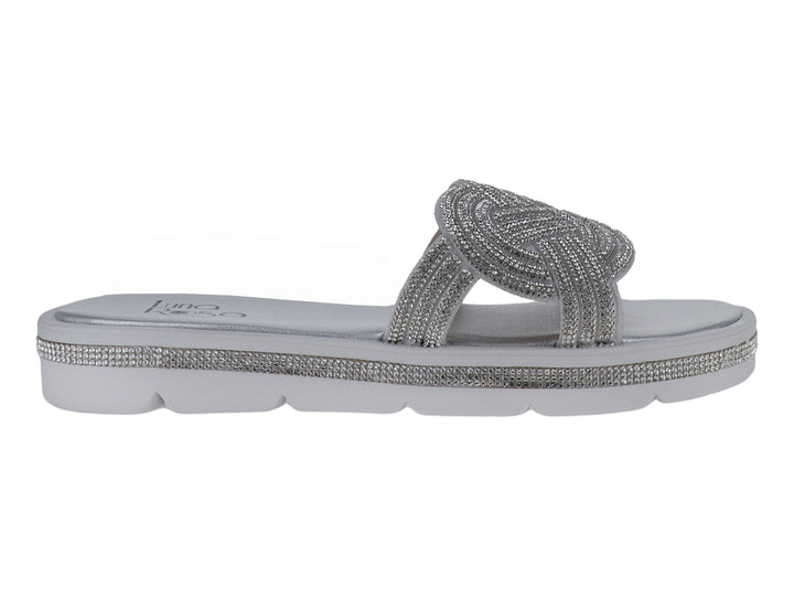 Sandalias planas color plata con tira brillante trenzada y suela blanca para niña.