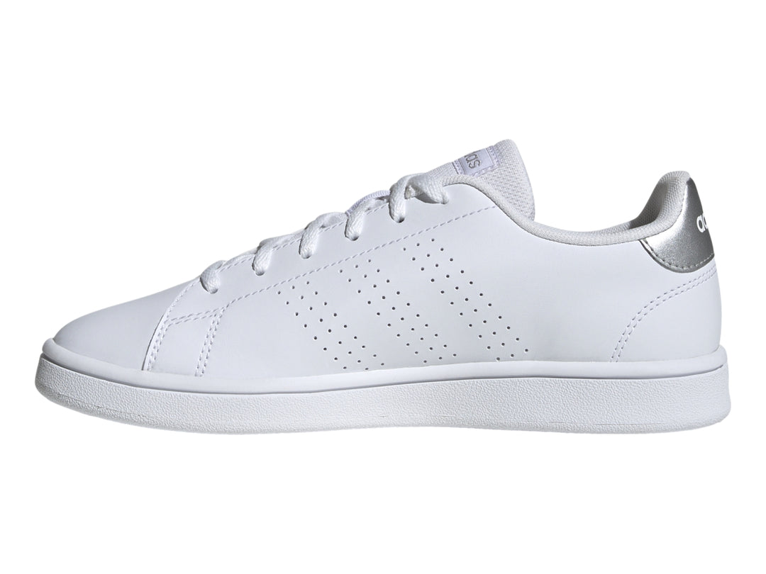 Tenis Adidas blancos con detalles plateados en el talón y suela blanca.