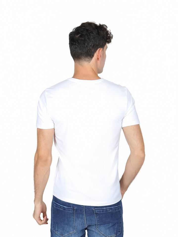 Hombre vistiendo una playera blanca de manga corta y cuello redondo con jeans azules.