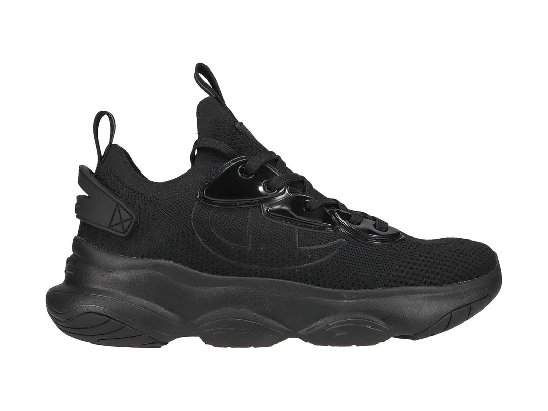 Tenis deportivos Champion color negro con suela ancha y detalles brillantes, diseñados para niños.