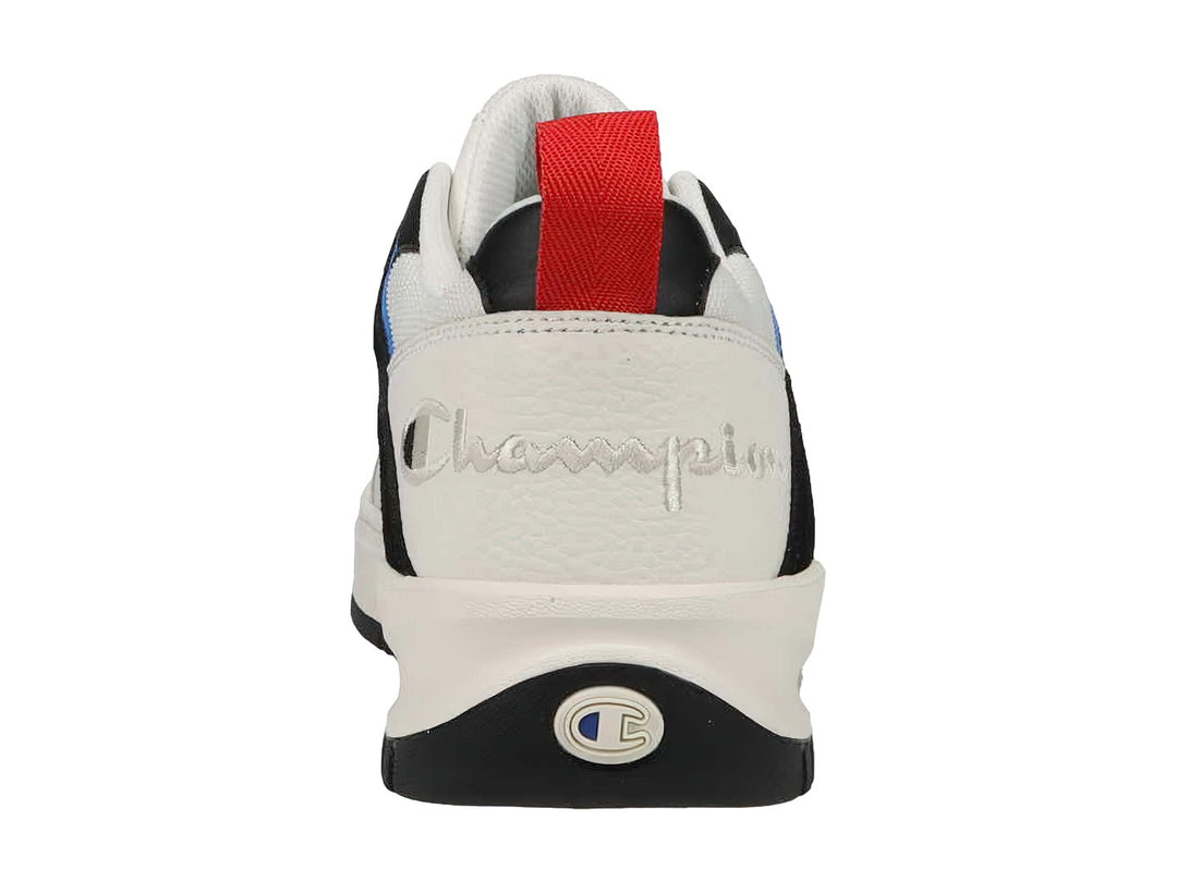 Tenis Champion blancos con detalles en azul y negro, suela blanca y lengüeta roja trasera.
