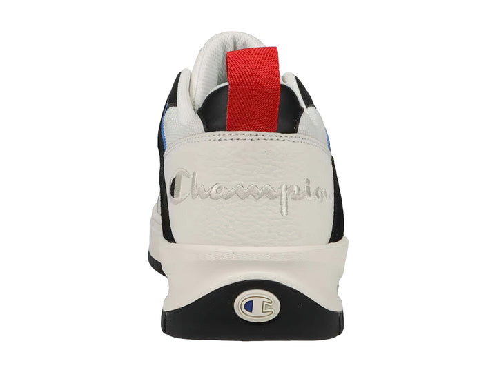 Tenis Champion blancos con detalles en azul y negro, suela blanca y lengüeta roja trasera.