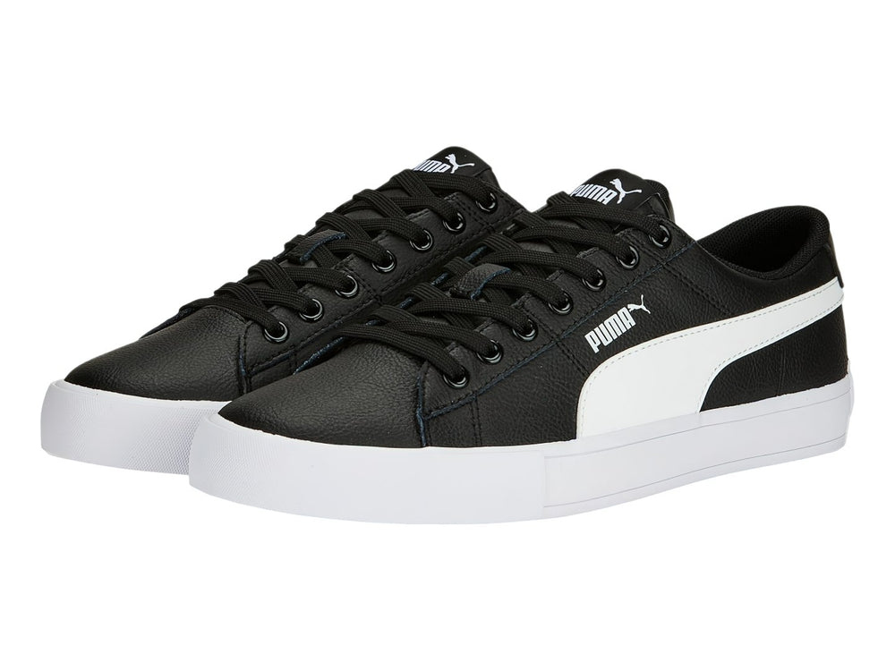 Tenis PUMA BARI CASUAL color negro con franja lateral y suela blanca.