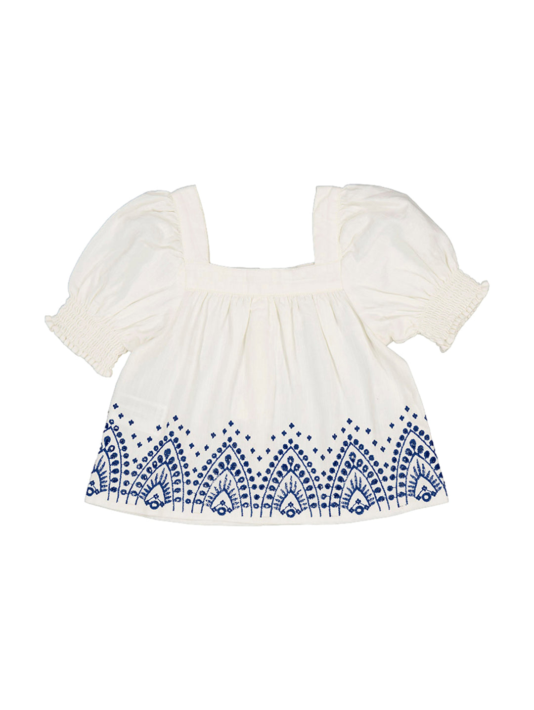 Blusón blanco para niña con mangas abullonadas y bordados azules en el borde inferior.