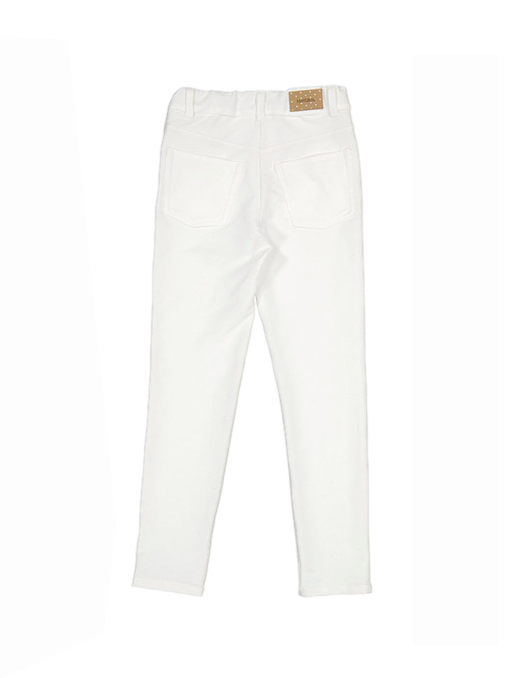 Pantalón color crudo para niña con detalles decorativos laterales.