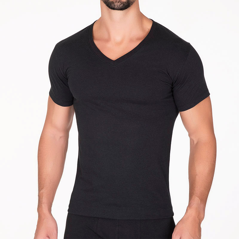 Hombre vistiendo una playera interior de color negro con cuello en V y manga corta.