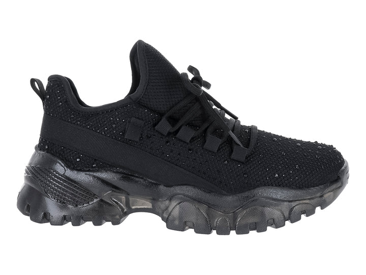 Tenis deportivo negro Andrax con suela gruesa y tejido de malla.