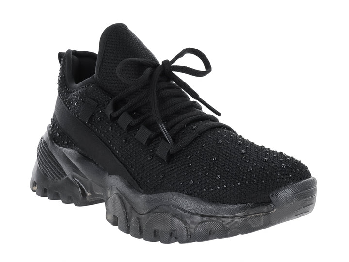 Tenis deportivo negro Andrax con suela gruesa y tejido de malla.