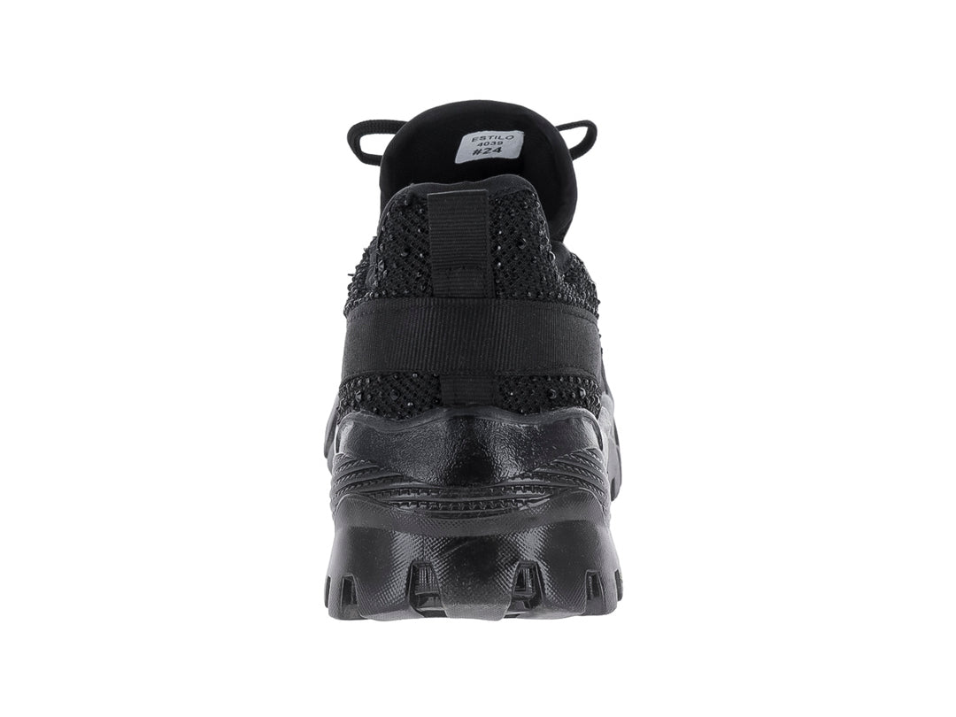 Tenis deportivo negro Andrax con suela gruesa y tejido de malla.