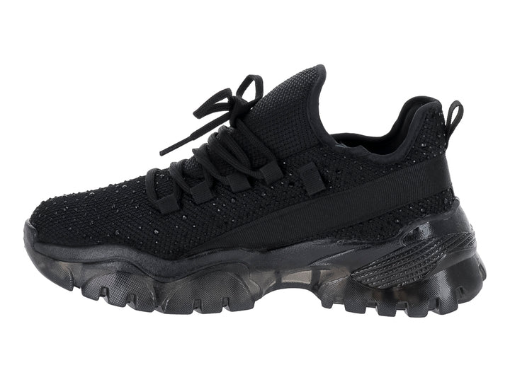 Tenis deportivo negro Andrax con suela gruesa y tejido de malla.