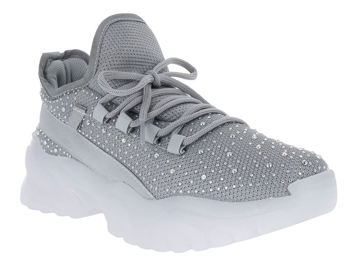 Tenis plateados con detalles brillantes y suela blanca gruesa para niña.