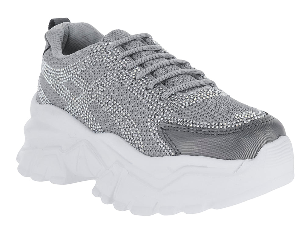 Tenis deportivos color gris con suela blanca gruesa y cordones.