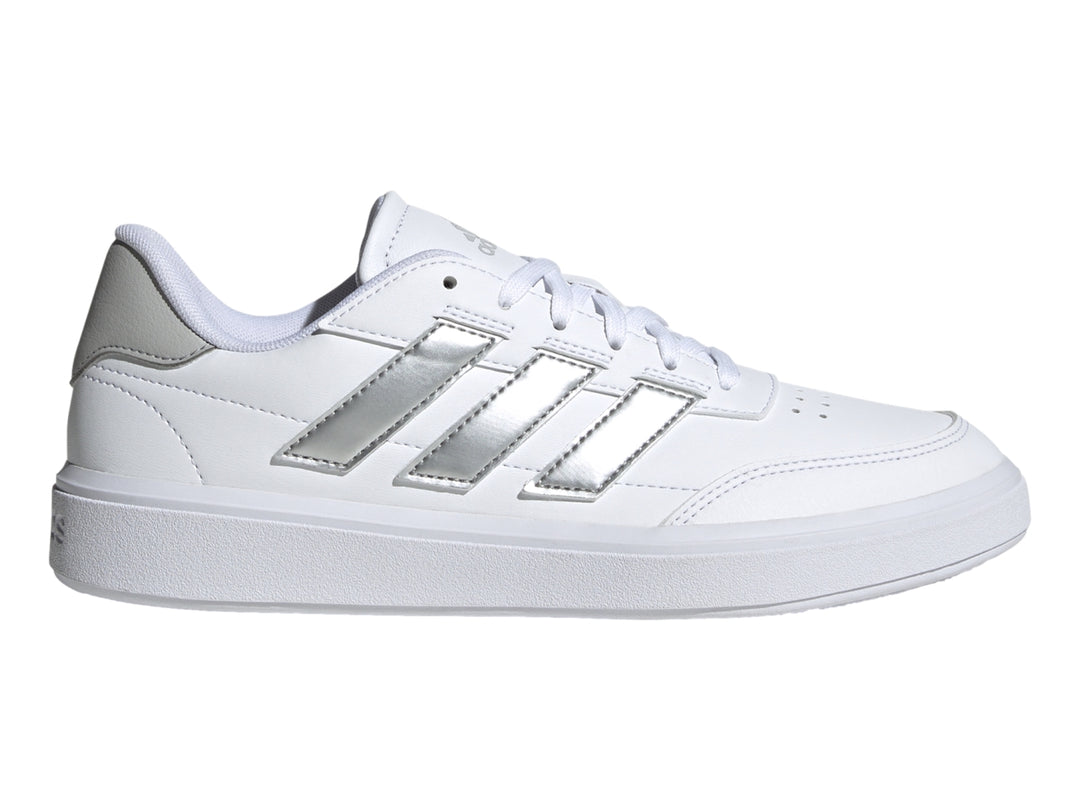 Tenis Adidas blancos con tres franjas plateadas y detalle gris en el talón.