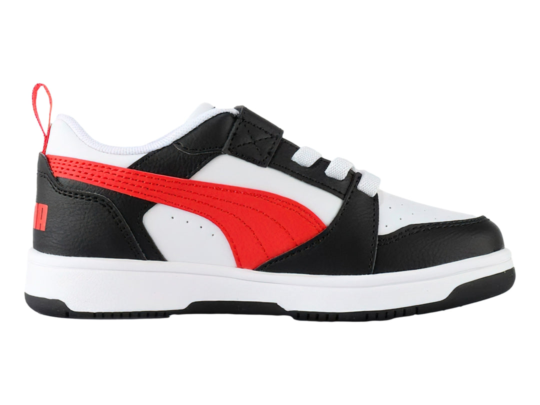 Tenis PUMA Rebound V6 Lo AC+PS en colores blanco, negro y rojo con cierre de velcro para niños.