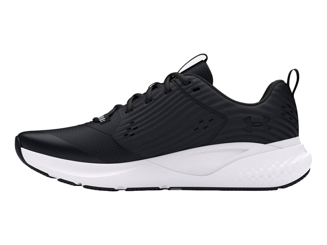 Tenis deportivos Under Armour color negro con suela blanca y logotipo blanco.