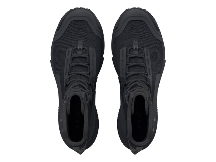 Bota deportiva Under Armour Charged Valsetz en color negro, diseño táctico de caña media con suela gruesa.