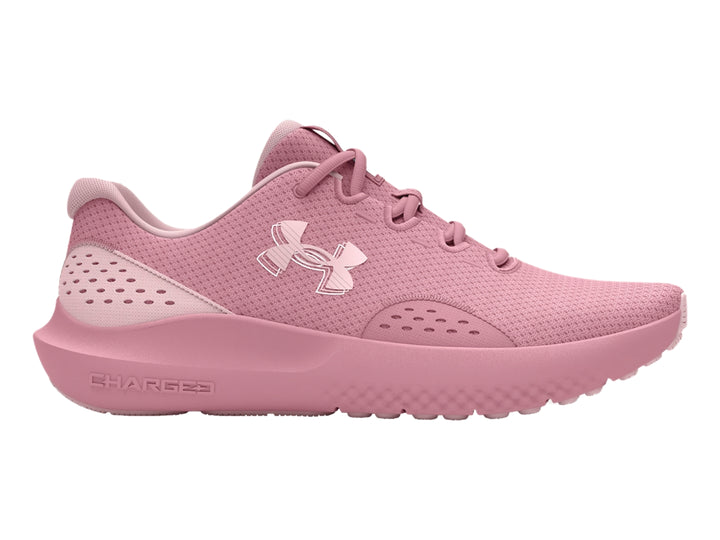 Tenis deportivos Under Armour de color rosa con suela Charged y malla transpirable.