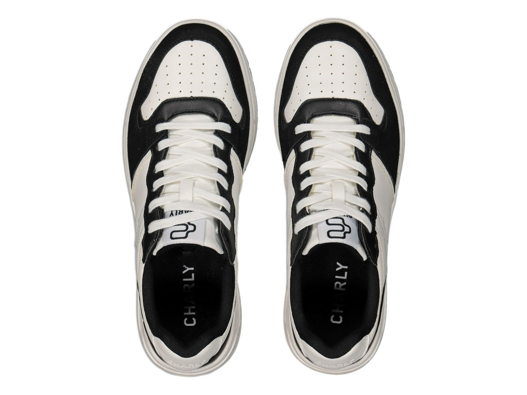 Tenis deportivos marca Charly en colores blanco y negro con suela blanca y detalles negros.