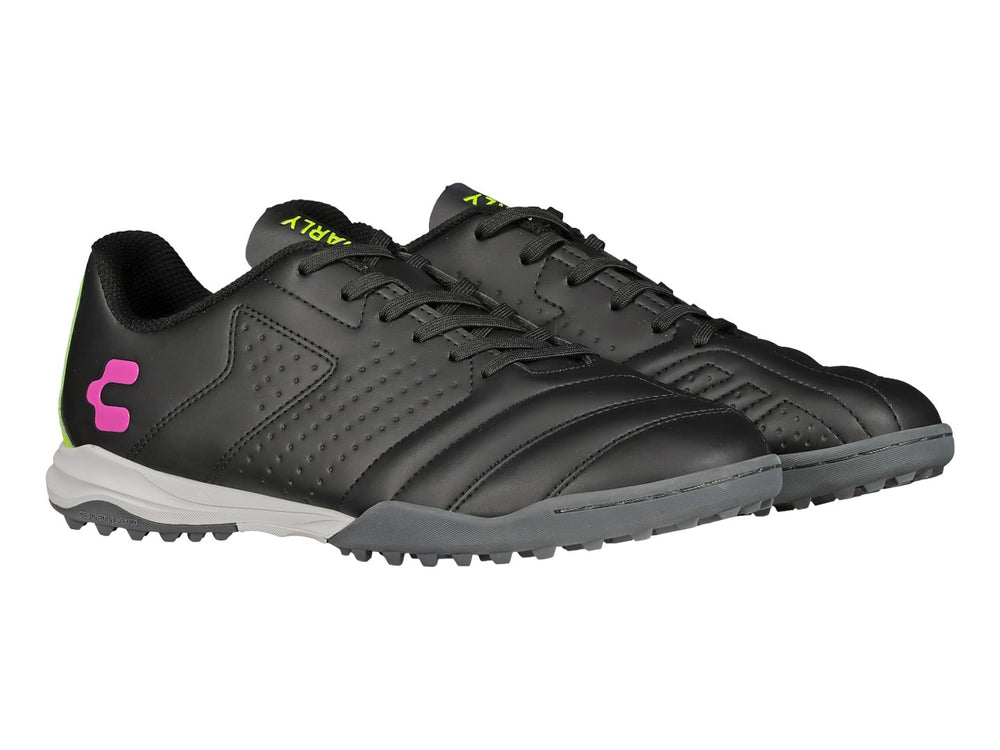 Zapato de fútbol Charly negro con detalles en verde lima y rosa, suela para césped sintético.