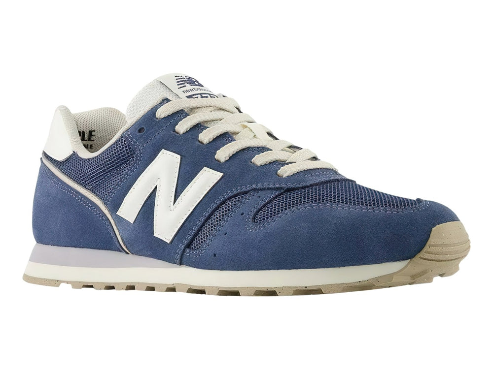 Tenis New Balance modelo 373 en color azul vintage indigo con detalles y suela en blanco y gris.