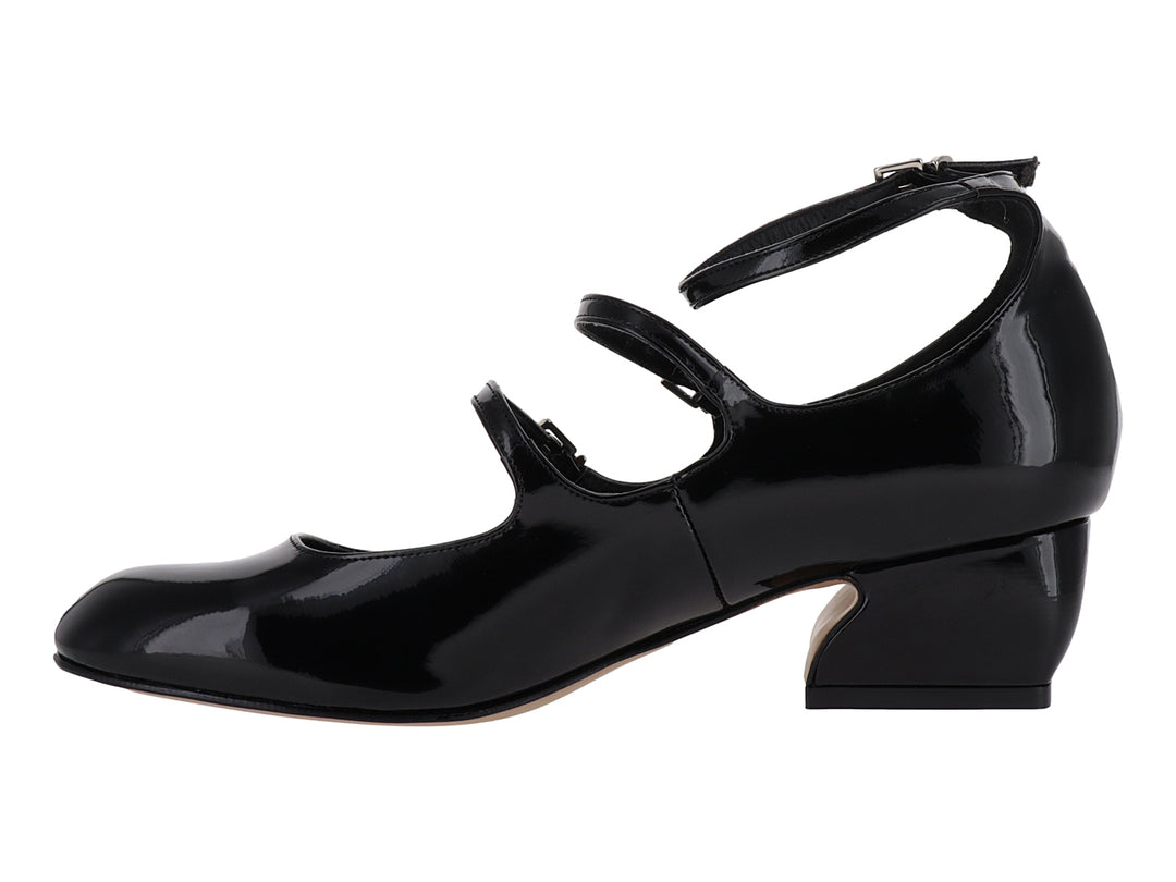 Zapato de tacón bajo en charol negro con tres correas ajustables y hebillas plateadas.
