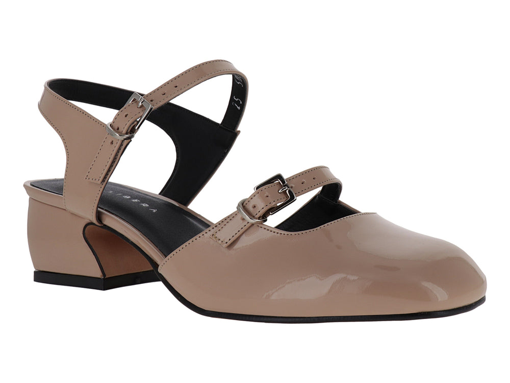 Zapato de charol sintético color nude con tacón bajo y correa ajustable al tobillo.