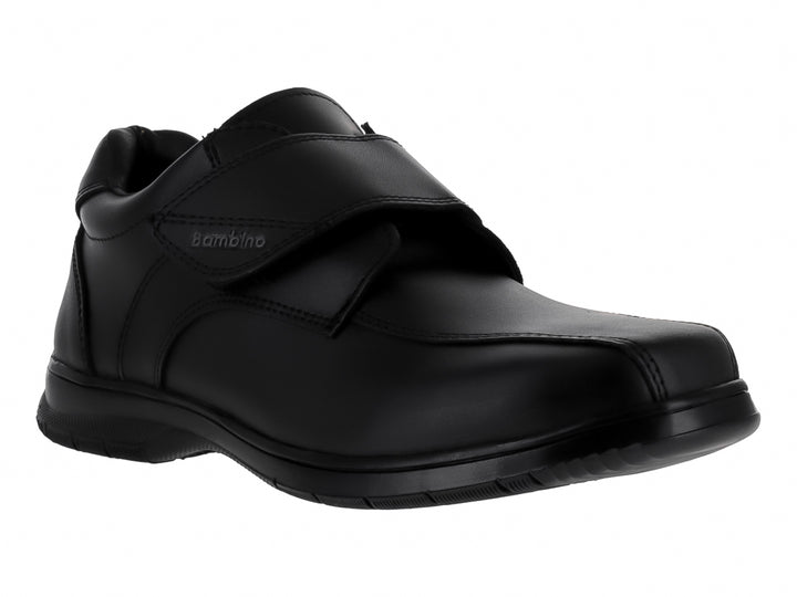 Zapato formal negro para niño con correa de velcro y suela negra.
