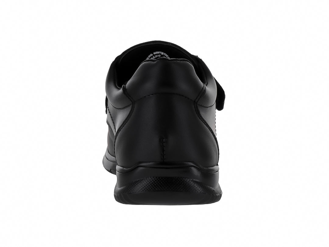 Zapato escolar negro para niño con cierre de velcro y suela cómoda.
