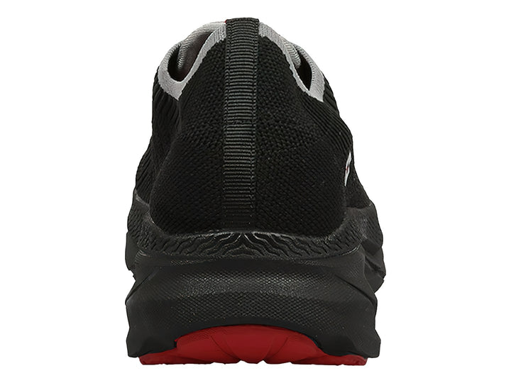 Tenis deportivos Lotto color negro con detalles en rojo y gris, diseño slip-on sin cordones.