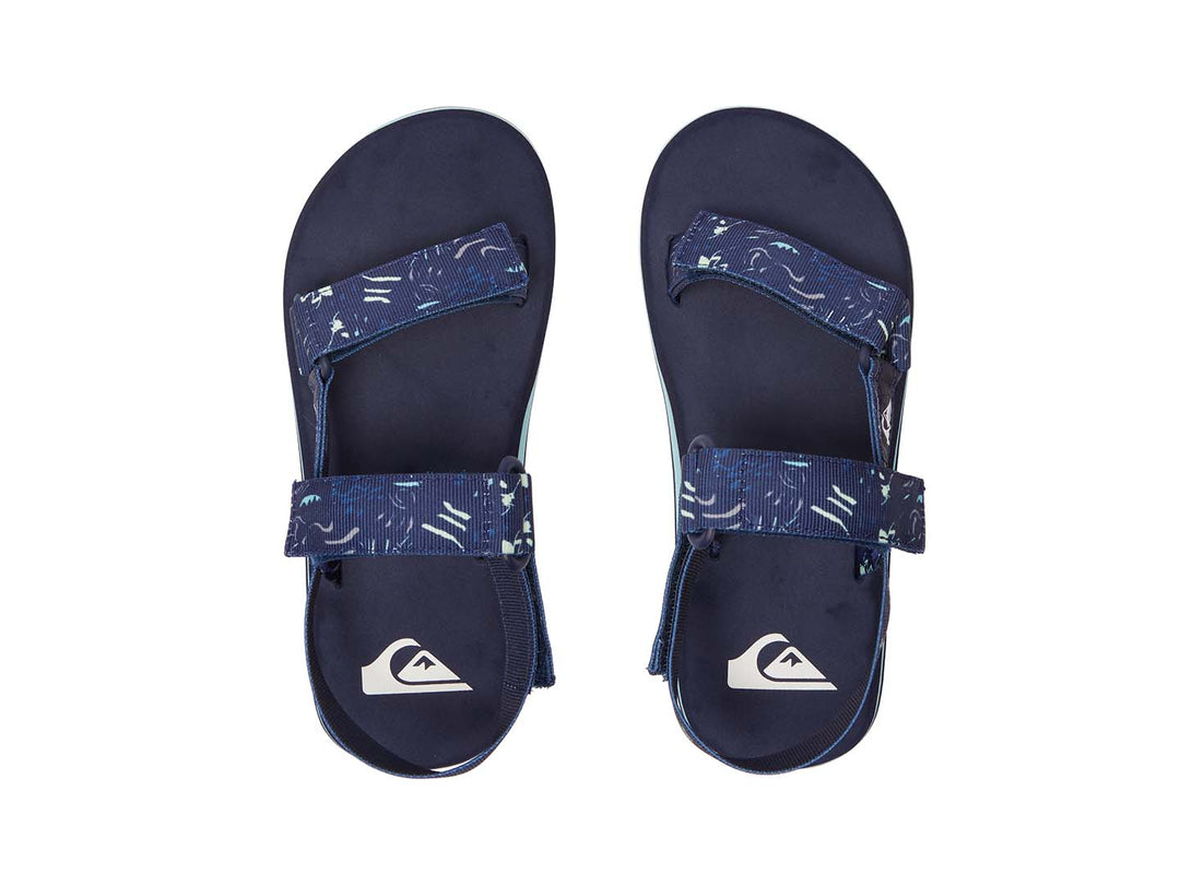 Sandalia Quiksilver azul marino con correas ajustables y suela con franja azul claro.