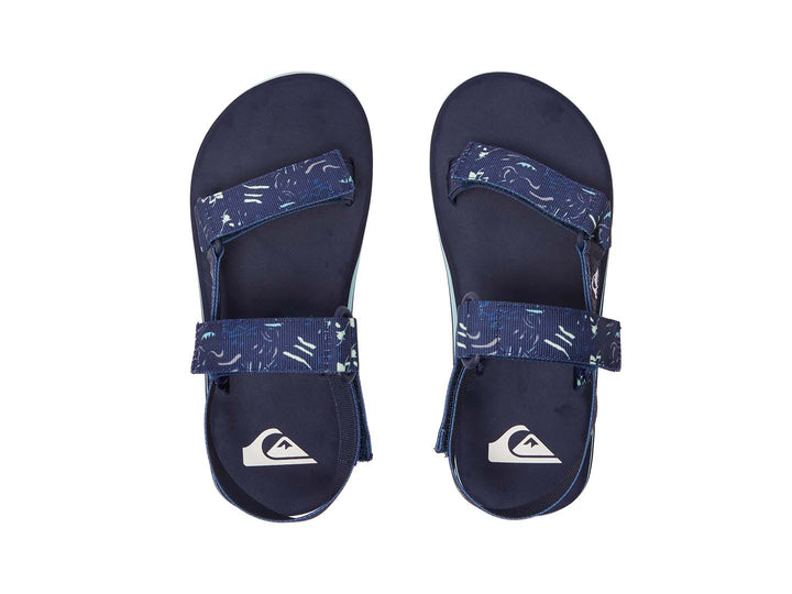 Sandalia Quiksilver azul marino con correas ajustables y suela con franja azul claro.