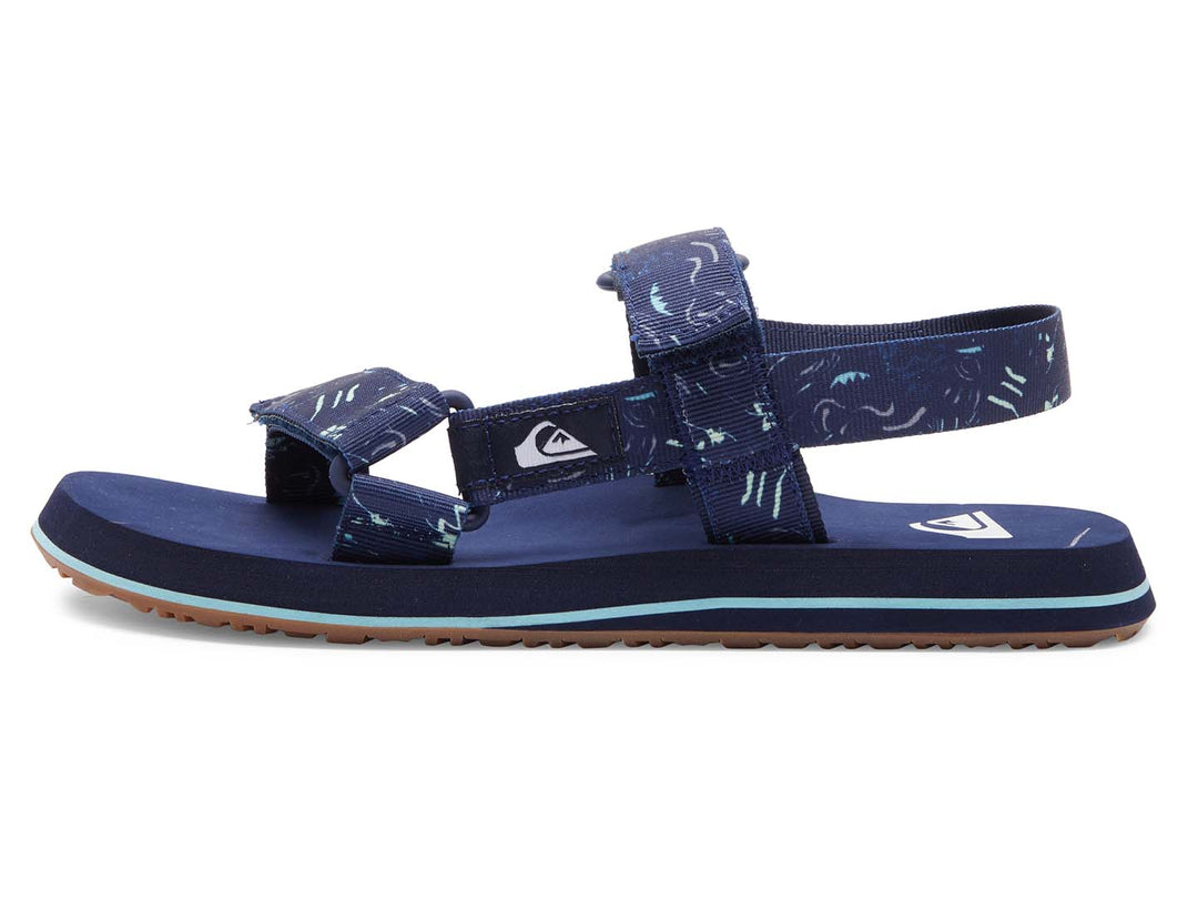 Sandalia Quiksilver azul marino con correas ajustables y suela con franja azul claro.