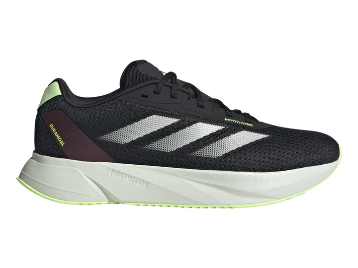 Tenis deportivos Adidas color negro con rayas plateadas y suela gris claro.