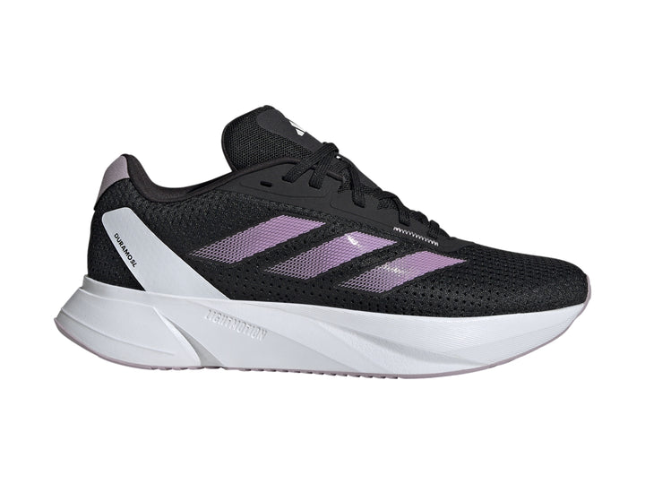 Tenis deportivos Adidas color negro con franjas lila y suela blanca.
