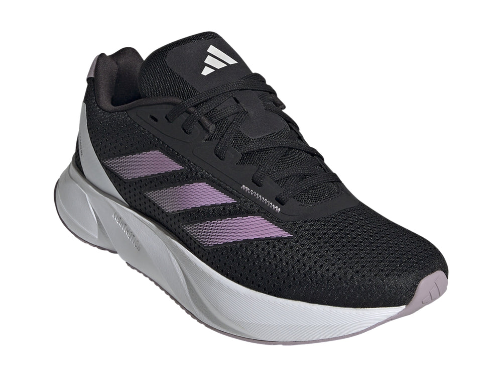 Tenis deportivos Adidas color negro con franjas lila y suela blanca.