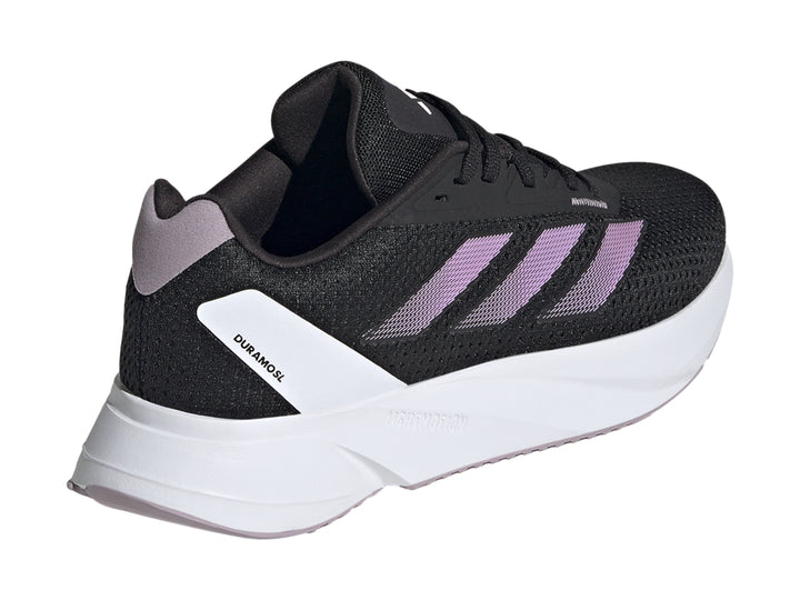Tenis deportivos Adidas color negro con franjas lila y suela blanca.