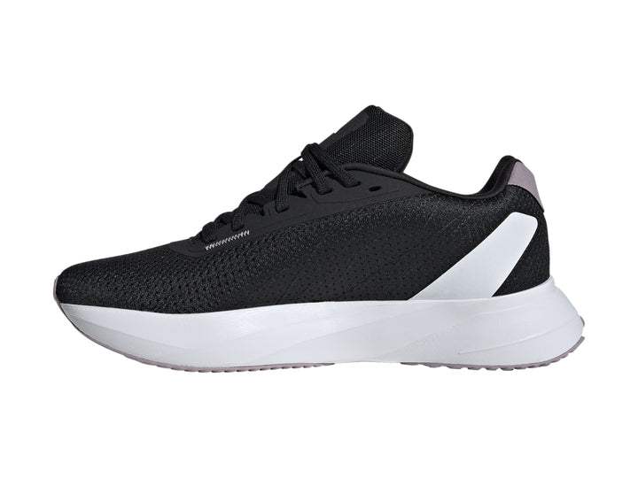Tenis deportivos Adidas color negro con franjas lila y suela blanca.