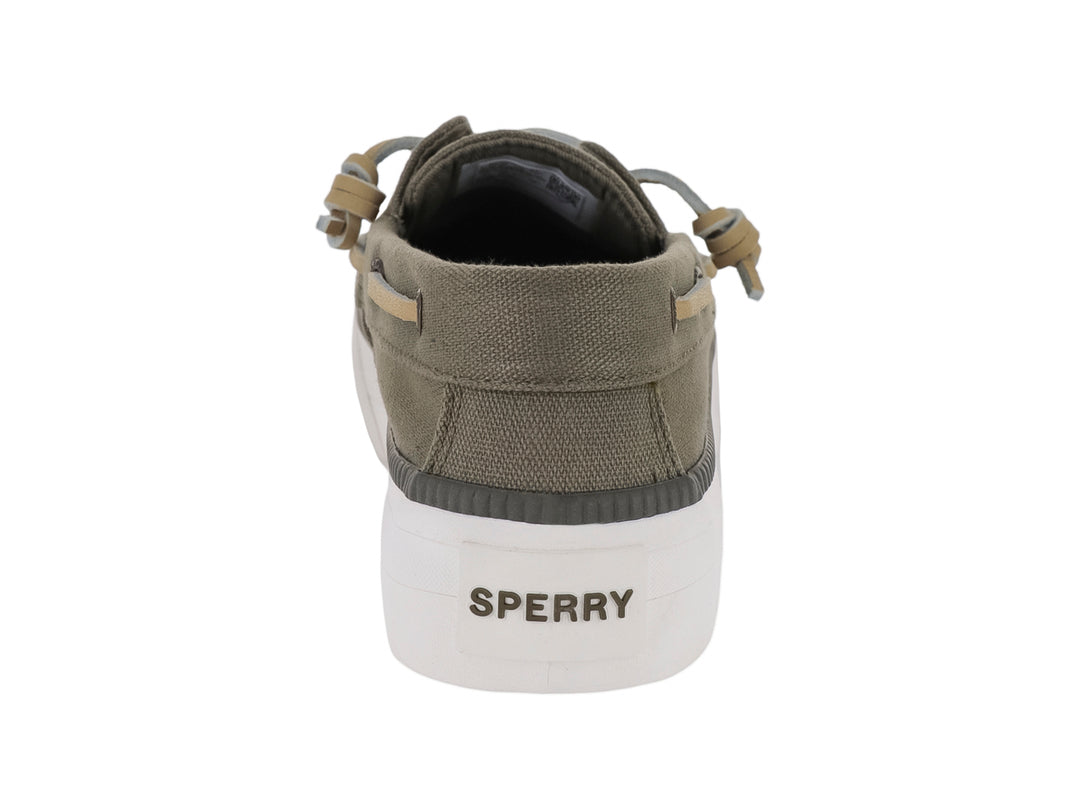 Zapato Sperry estilo náutico en color verde con suela blanca ancha y cordones beige.