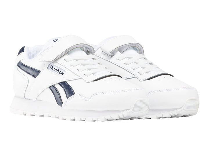Tenis Reebok Royal Glide blancos con detalles en azul marino y cierre de velcro.