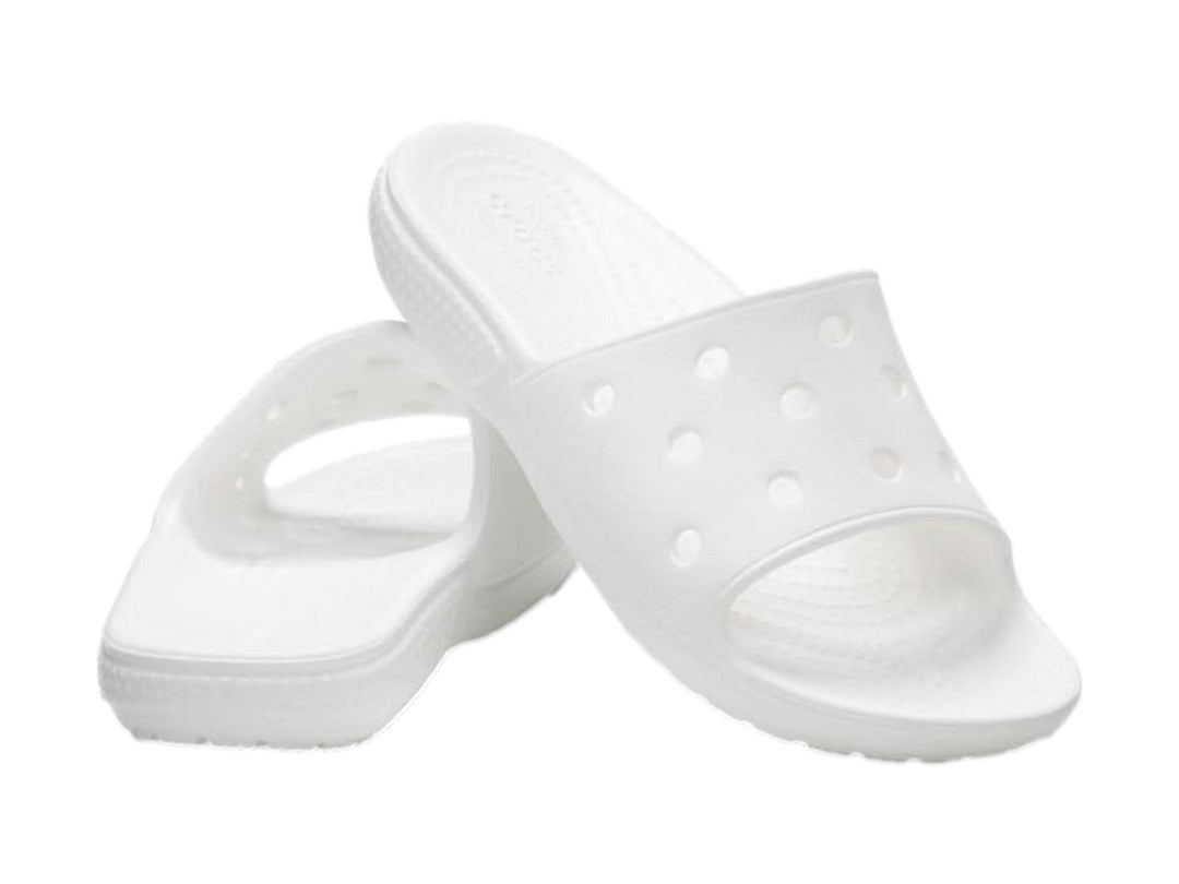 Par de sandalias Crocs Classic Slide V2 en color blanco con perforaciones circulares en la banda superior.