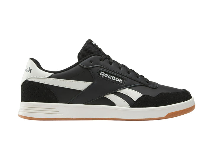 Tenis Reebok Court Advance color negro con detalles en blanco y suela de goma color miel.