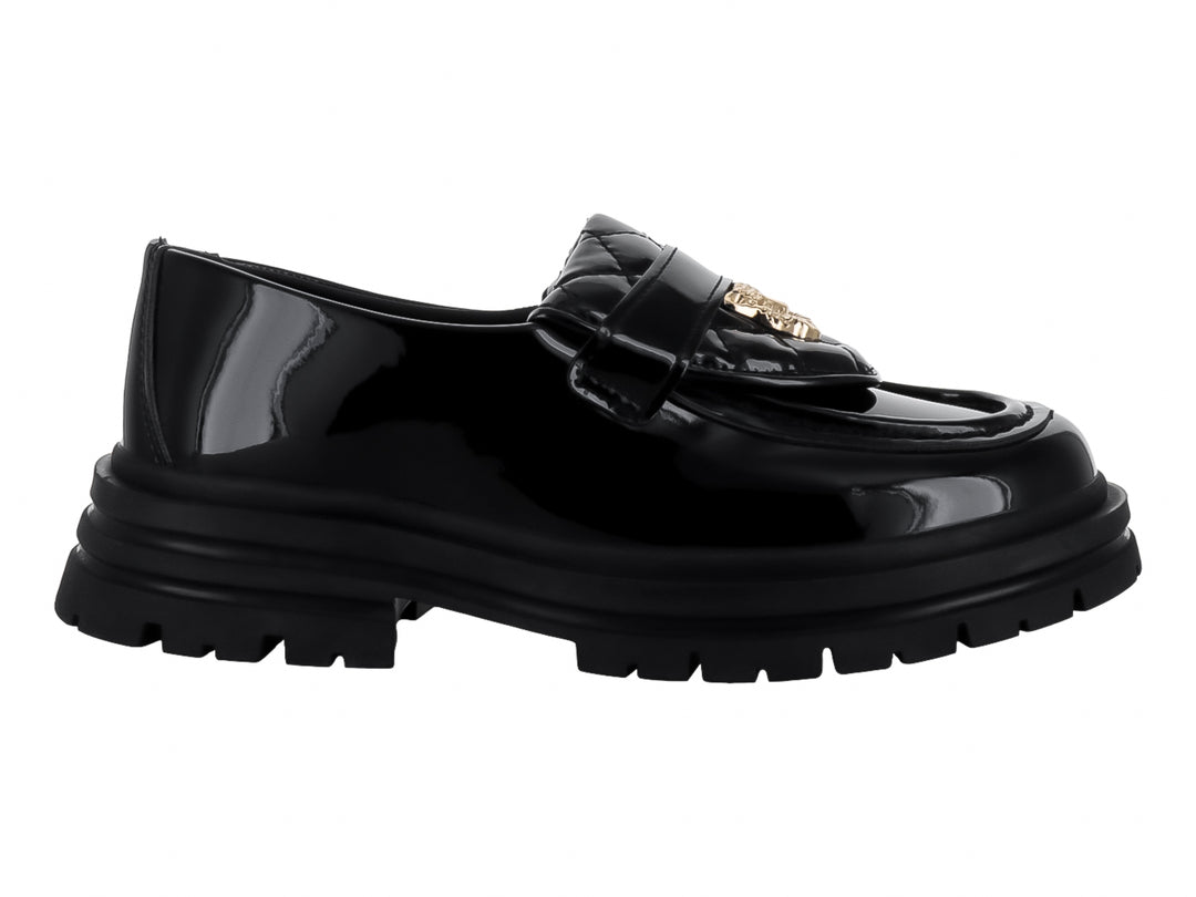 Zapato mocasín de charol negro con suela track gruesa y detalle dorado en la parte superior.