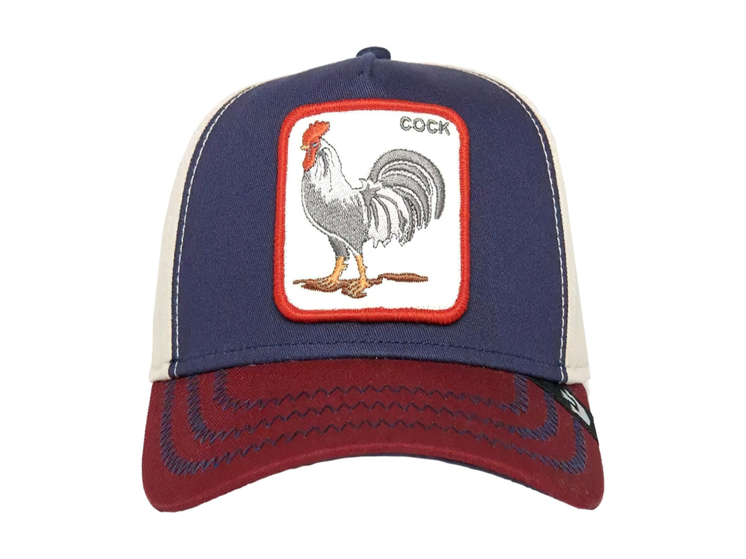 Gorra Goorin Bros en colores azul marino, blanco y rojo con un parche bordado de un gallo en el frente.