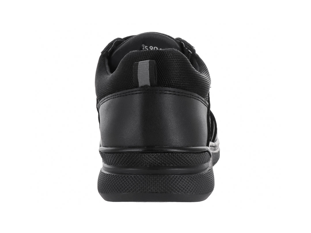 Zapato infantil color negro con cierre de velcro y suela antideslizante.