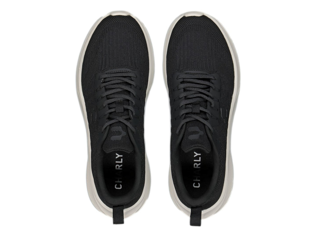 Tenis deportivos Charly color negro con suela blanca y tejido transpirable.