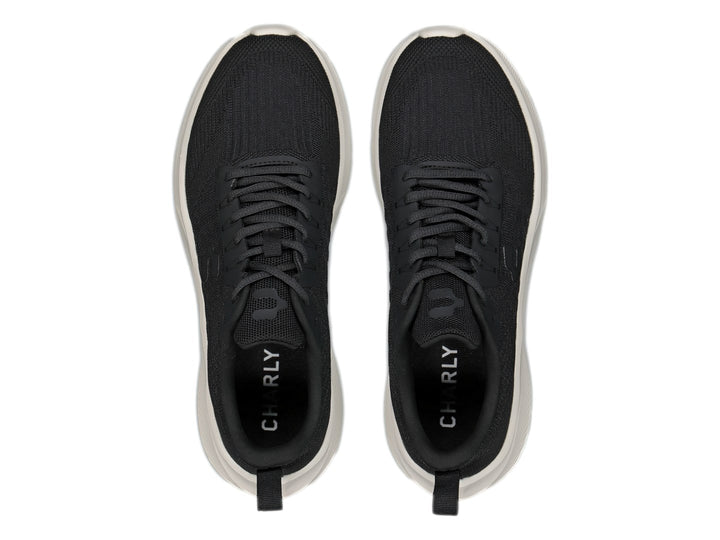 Tenis deportivos Charly color negro con suela blanca y tejido transpirable.