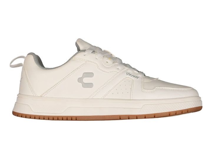 Tenis deportivos Charly de color blanco con suela marrón, vista lateral.
